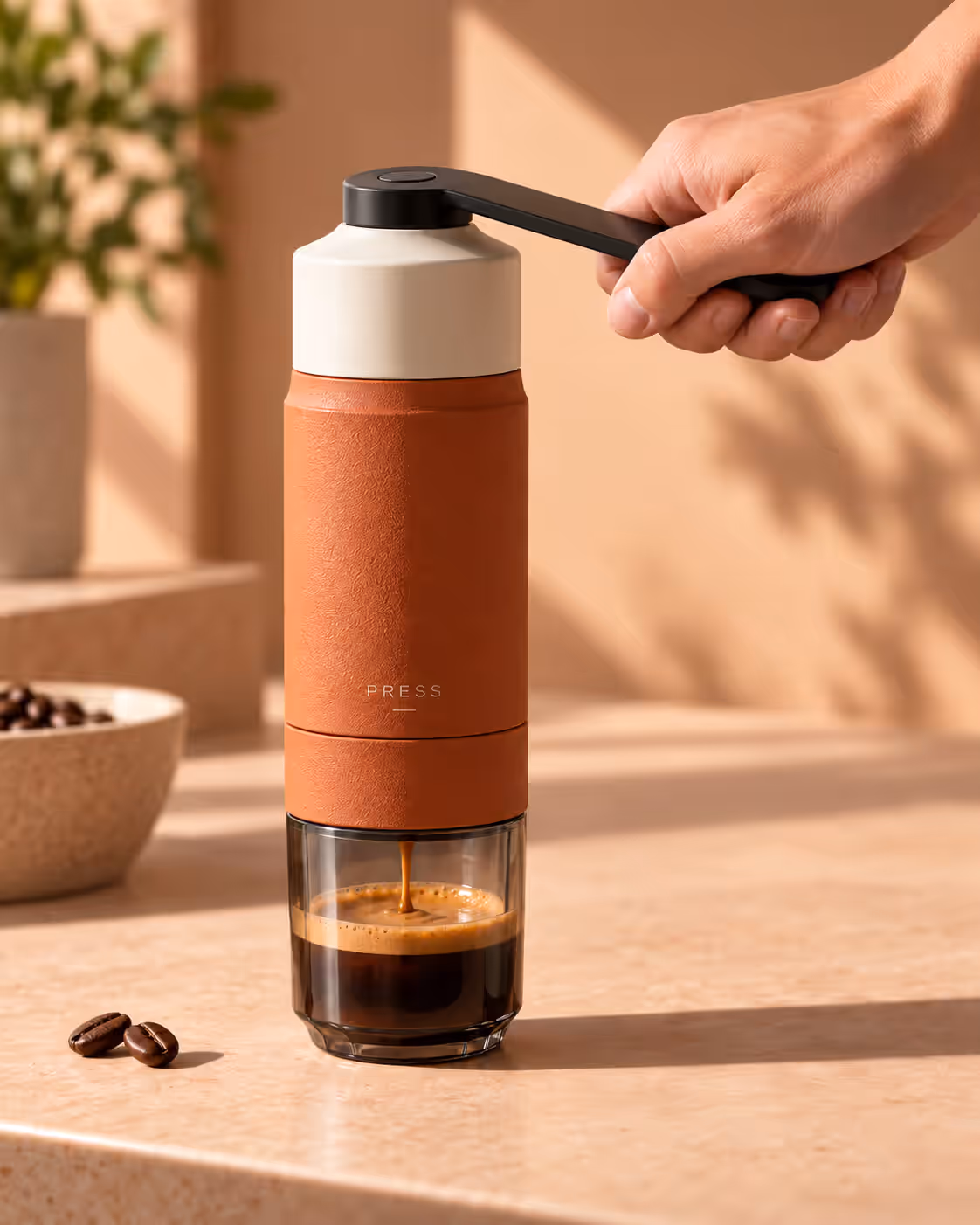 A hand working the lever as espresso pours into the glass base